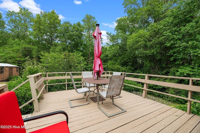 wooden deck with outdoor dining area