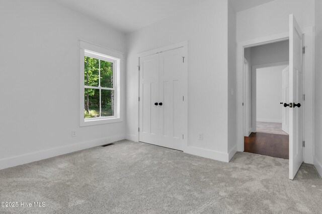 140 E Ag Dr, New Bern, NC 28562 - unfurnished bedroom featuring carpet, baseboards, and a closet