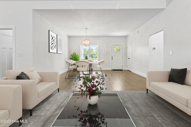 140 E Ag Dr, New Bern, NC 28562 - living room with wood finished floors, a chandelier, and baseboards