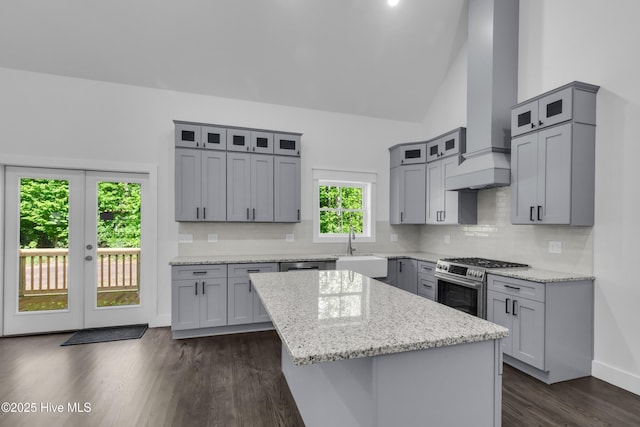 140 E Ag Dr, New Bern, NC 28562 - kitchen with stainless steel gas range, a sink, wall chimney range hood, a center island, and gray cabinetry