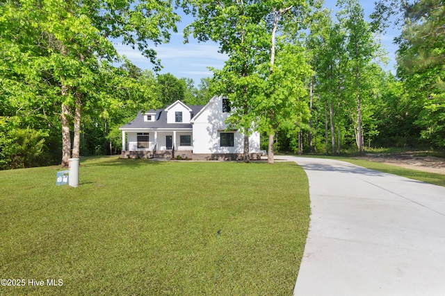 140 E Ag Dr, New Bern, NC 28562 - view of front facade featuring concrete driveway, a front yard, and a porch