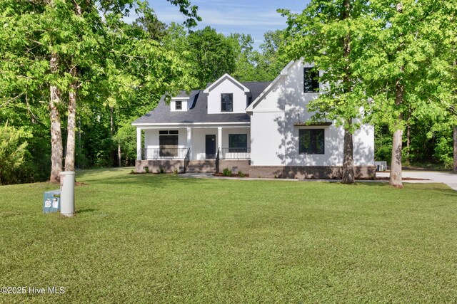 140 E Ag Dr, New Bern, NC 28562 - view of front of home featuring a porch, a front lawn, and brick siding