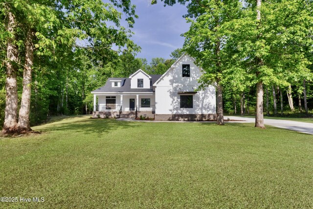 140 E Ag Dr, New Bern, NC 28562 - view of front of property with a front yard, view of wooded area, and a porch