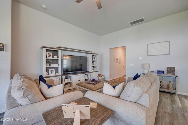 6909 English Holly Ct SW, Ocean Isle Beach, NC 28469 - living room with wood finished floors, a ceiling fan, and baseboards