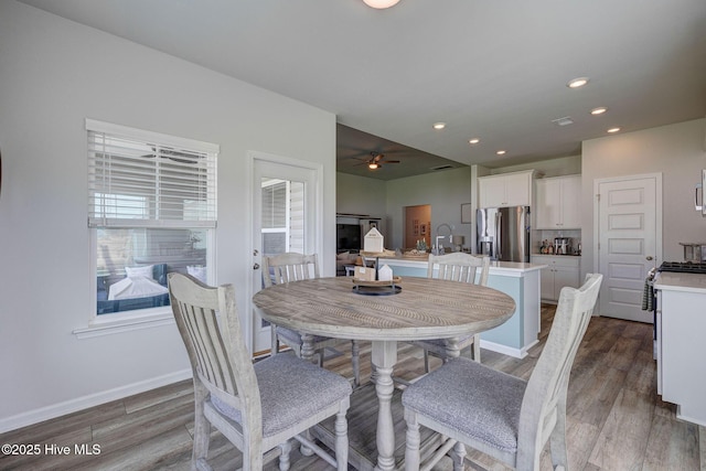 6909 English Holly Ct SW, Ocean Isle Beach, NC 28469 - dining area featuring wood finished floors, a ceiling fan, baseboards, and recessed lighting