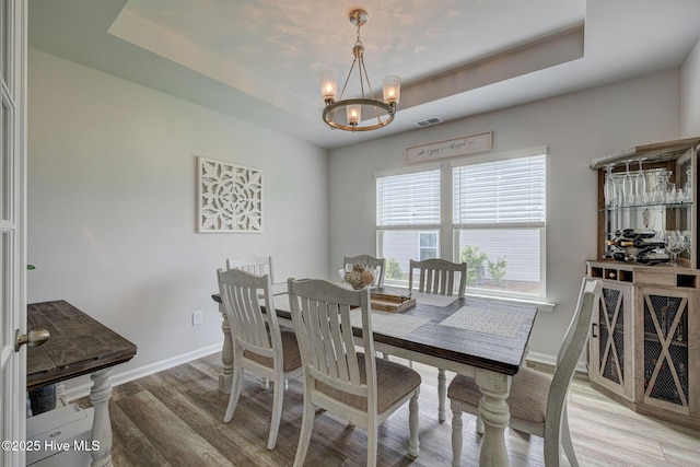 6909 English Holly Ct SW, Ocean Isle Beach, NC 28469 - dining space with a chandelier, light wood finished floors, and baseboards