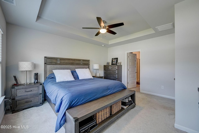 6909 English Holly Ct SW, Ocean Isle Beach, NC 28469 - bedroom featuring a raised ceiling, light colored carpet, baseboards, and ceiling fan