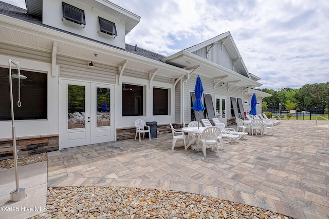 6909 English Holly Ct SW, Ocean Isle Beach, NC 28469 - view of patio with french doors, outdoor dining area, and fence