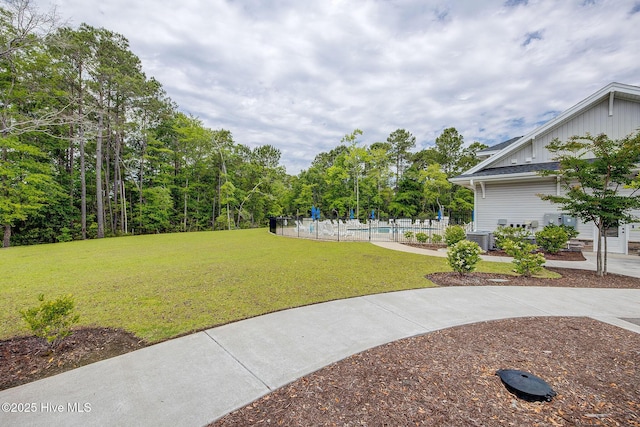 6909 English Holly Ct SW, Ocean Isle Beach, NC 28469 - view of yard featuring an outdoor pool and central air condition unit