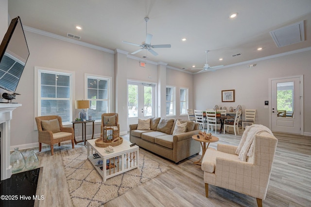 6909 English Holly Ct SW, Ocean Isle Beach, NC 28469 - living area featuring ornamental molding, ceiling fan, plenty of natural light, light wood-style flooring, and recessed lighting