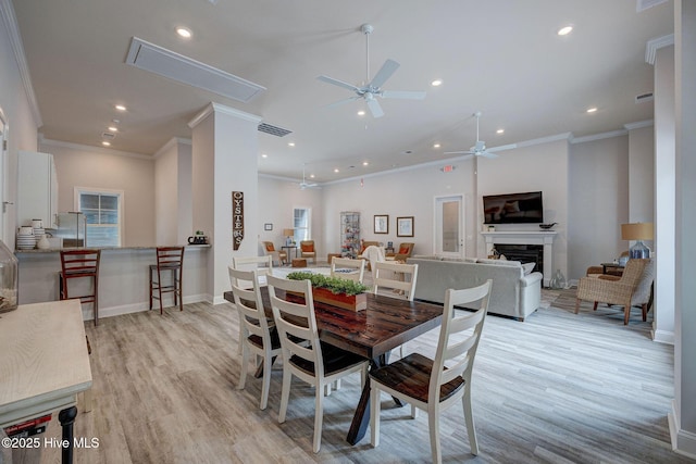 6909 English Holly Ct SW, Ocean Isle Beach, NC 28469 - dining space featuring a ceiling fan, light wood finished floors, recessed lighting, attic access, and ornamental molding