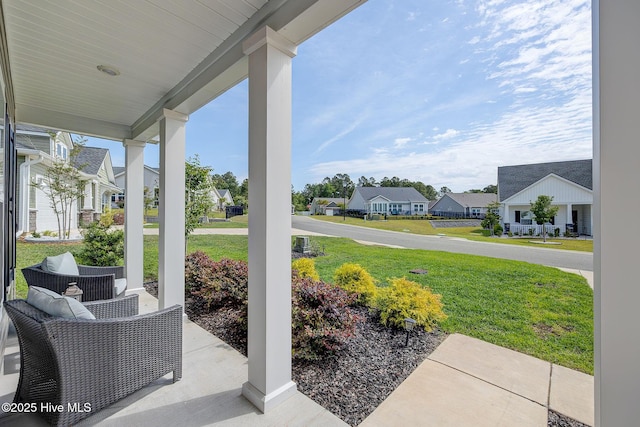 6909 English Holly Ct SW, Ocean Isle Beach, NC 28469 - view of patio / terrace with a porch and a residential view