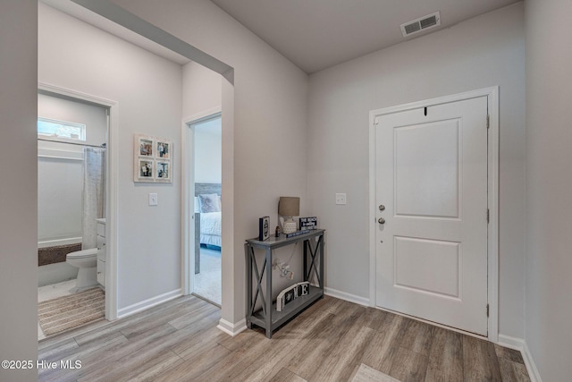 6909 English Holly Ct SW, Ocean Isle Beach, NC 28469 - foyer entrance featuring light wood-style flooring and baseboards
