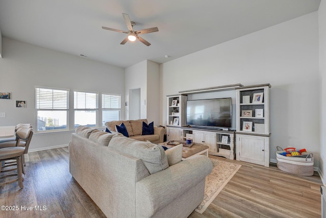 6909 English Holly Ct SW, Ocean Isle Beach, NC 28469 - living area with a ceiling fan, light wood finished floors, and baseboards