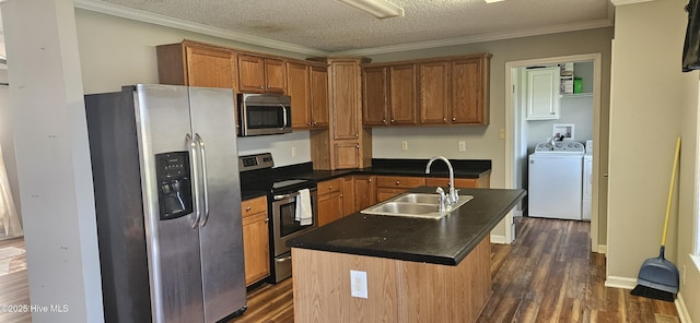 1970 Old Raleigh Rd, Clinton, NC 28328 - kitchen with appliances with stainless steel finishes, a sink, washer and dryer, dark wood-style flooring, and dark countertops