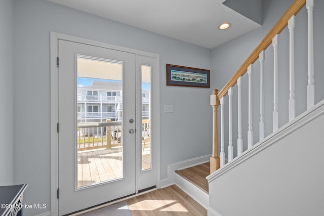 entryway featuring stairs, wood finished floors, recessed lighting, and baseboards