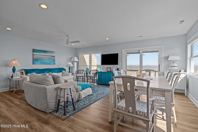 living area with wood finished floors, baseboards, and recessed lighting