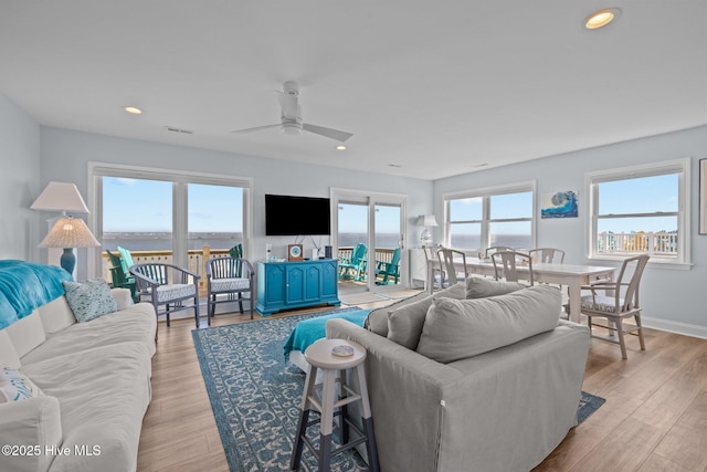living area featuring a ceiling fan, light wood-type flooring, recessed lighting, and baseboards