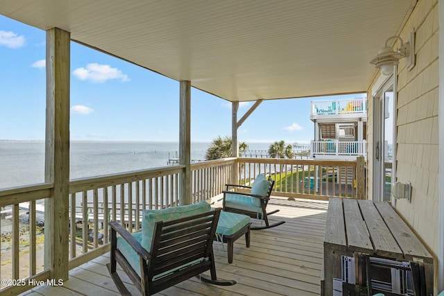 wooden terrace featuring a water view