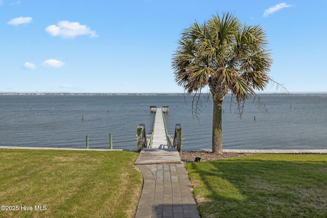 dock with a water view and a lawn