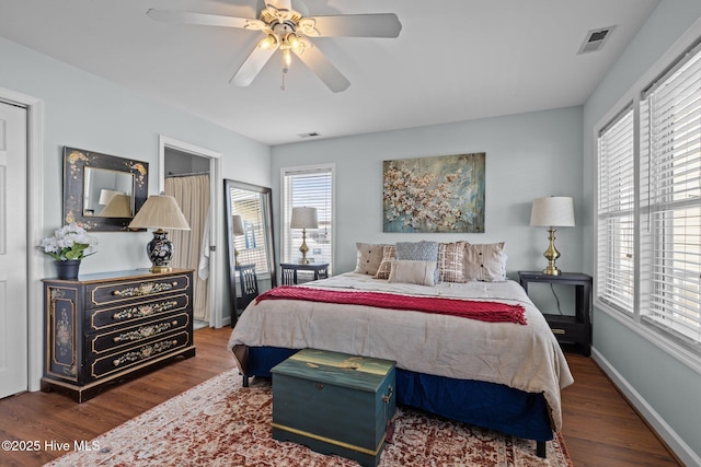 bedroom featuring wood finished floors, ceiling fan, and baseboards