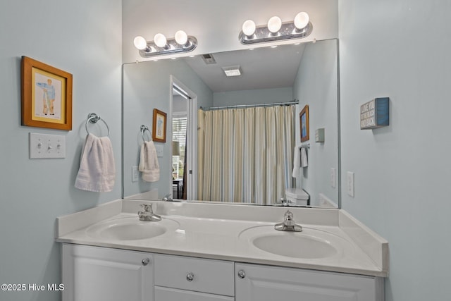 full bath featuring double vanity and curtained shower