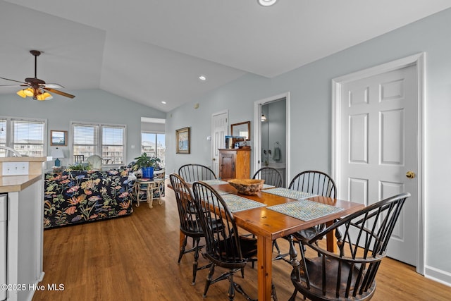dining space with vaulted ceiling, ceiling fan, light wood-type flooring, and recessed lighting
