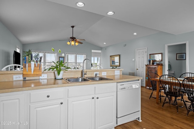 kitchen featuring dishwasher, a sink, ceiling fan, lofted ceiling, and wood finished floors