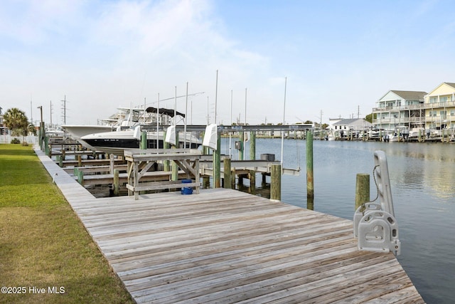 dock area with boat lift and a water view