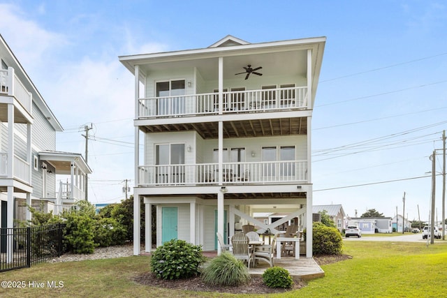 view of front of home with ceiling fan, a balcony, and a patio