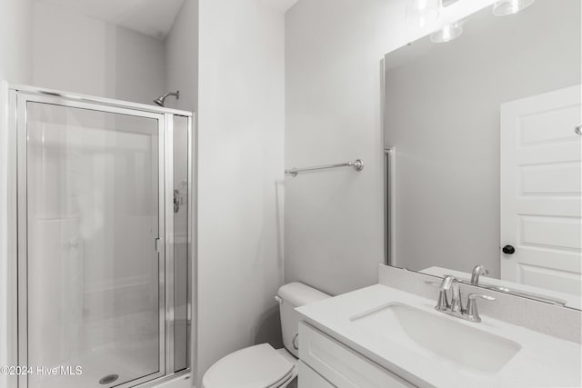 full bathroom with a shower stall, toilet, and vanity