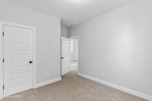 unfurnished bedroom with carpet and baseboards