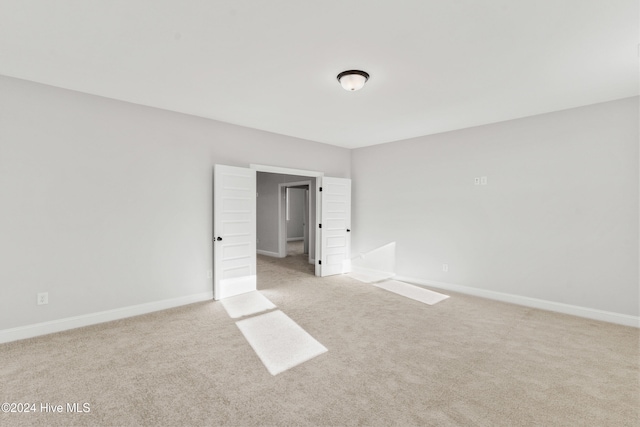 carpeted spare room with baseboards