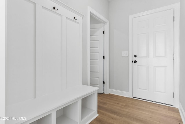 mudroom featuring baseboards and light wood-type flooring