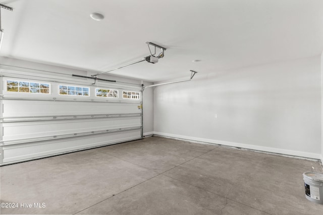 garage with a garage door opener and baseboards