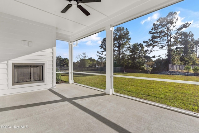 unfurnished sunroom with a ceiling fan