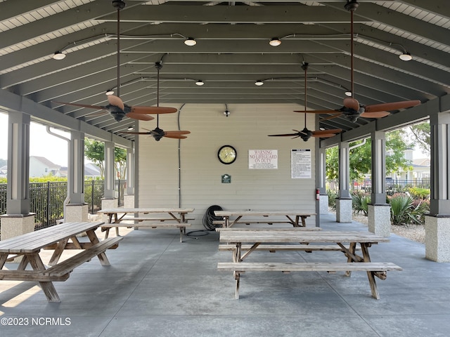 view of patio / terrace with ceiling fan and fence