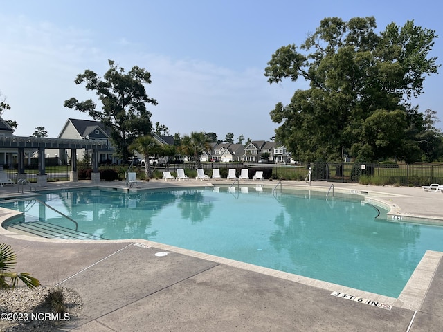 community pool featuring fence, a patio, and a pergola