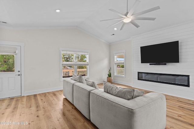 921 Whitecaps Ln, Carolina Beach, NC 28428 - living area featuring a fireplace, ceiling fan, crown molding, light wood-type flooring, and lofted ceiling