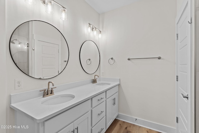 921 Whitecaps Ln, Carolina Beach, NC 28428 - full bathroom featuring double vanity, wood finished floors, and baseboards
