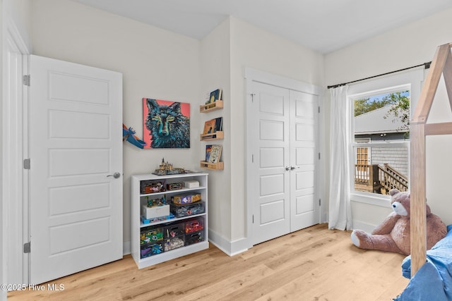 921 Whitecaps Ln, Carolina Beach, NC 28428 - bedroom with wood finished floors, a closet, and baseboards