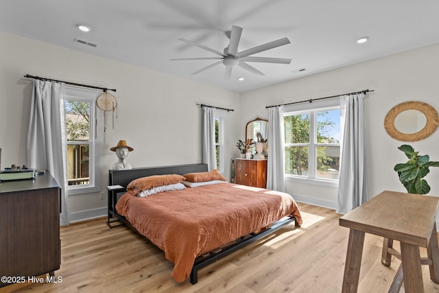921 Whitecaps Ln, Carolina Beach, NC 28428 - bedroom with multiple windows, light wood-style flooring, recessed lighting, and baseboards