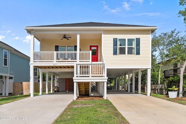 921 Whitecaps Ln, Carolina Beach, NC 28428 - raised beach house featuring a carport, concrete driveway, and covered porch