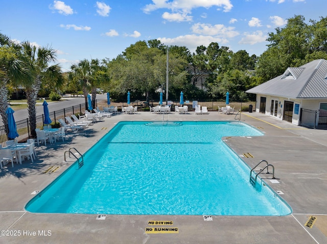 921 Whitecaps Ln, Carolina Beach, NC 28428 - community pool featuring a patio and view of wooded area