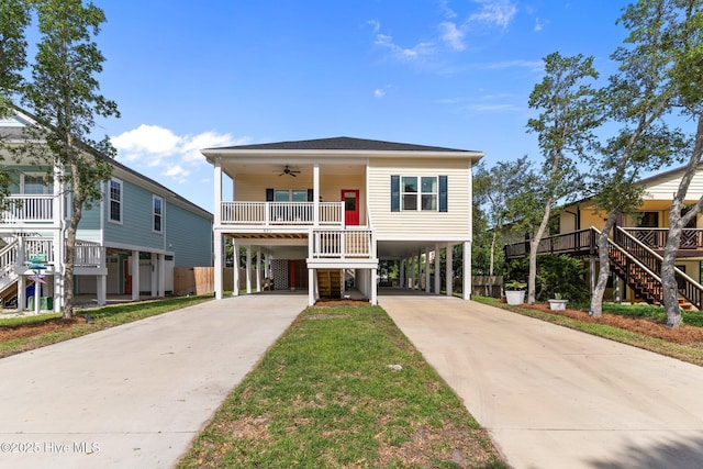 921 Whitecaps Ln, Carolina Beach, NC 28428 - coastal inspired home with stairway, a carport, and a ceiling fan