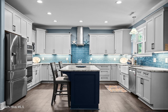 3528 Cordgrass Ln, Wilmington, NC 28409 - kitchen featuring appliances with stainless steel finishes, a sink, island exhaust hood, recessed lighting, and a kitchen island