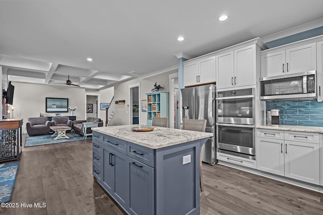 3528 Cordgrass Ln, Wilmington, NC 28409 - kitchen featuring appliances with stainless steel finishes, recessed lighting, white cabinets, dark wood-style floors, and a kitchen island