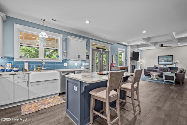3528 Cordgrass Ln, Wilmington, NC 28409 - kitchen featuring dishwasher, a sink, recessed lighting, coffered ceiling, and backsplash