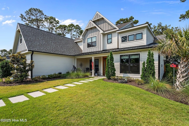 3528 Cordgrass Ln, Wilmington, NC 28409 - craftsman-style home with covered porch, board and batten siding, a front lawn, and a shingled roof