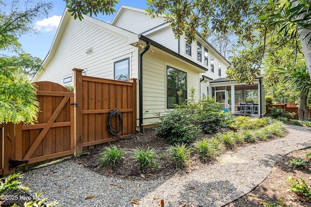 3528 Cordgrass Ln, Wilmington, NC 28409 - view of property exterior with a sunroom and a gate